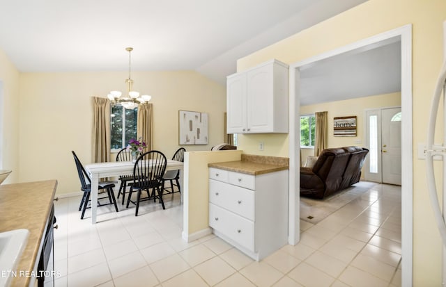 635 Gold Dust Dr, Pigeon Forge, TN 37863 - kitchen featuring vaulted ceiling, a chandelier, light tile patterned floors, white cabinets, and hanging light fixtures