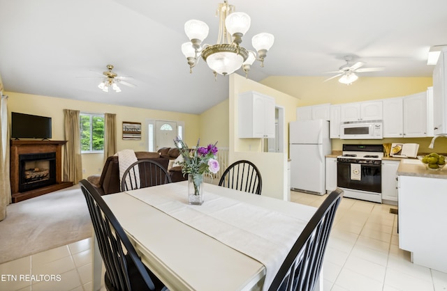 635 Gold Dust Dr, Pigeon Forge, TN 37863 - dining space with ceiling fan, lofted ceiling, a fireplace, light tile patterned floors, and a chandelier