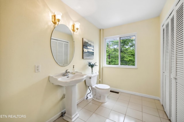 635 Gold Dust Dr, Pigeon Forge, TN 37863 - bathroom featuring a closet, baseboards, toilet, tile patterned flooring, and a sink