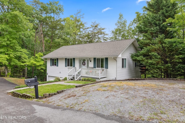635 Gold Dust Dr, Pigeon Forge, TN 37863 - ranch-style house featuring a porch, gravel driveway, and a shingled roof