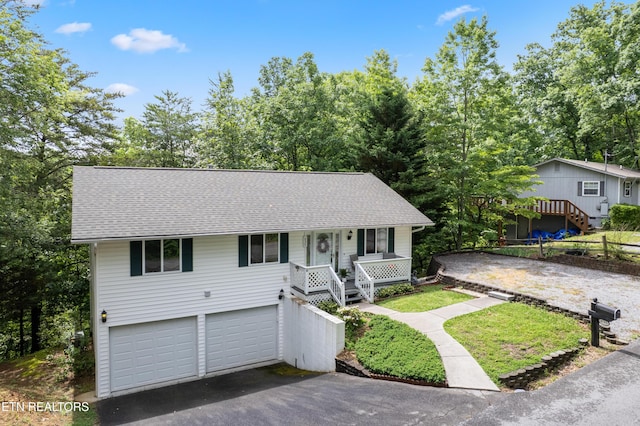 635 Gold Dust Dr, Pigeon Forge, TN 37863 - view of front of house featuring asphalt driveway, stairs, a shingled roof, a porch, and an attached garage