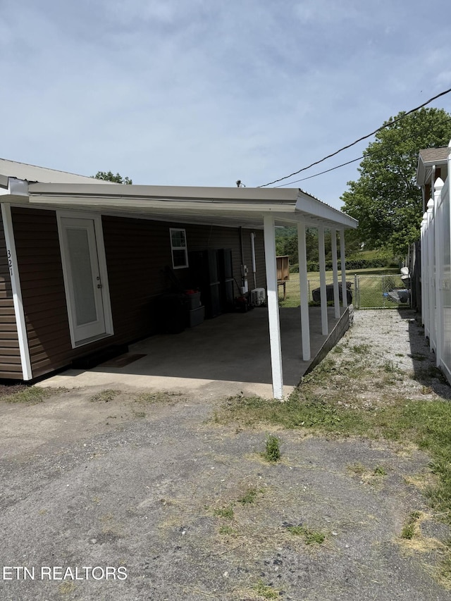321 Coleman St, Harrogate, TN 37752 - view of side of property with a carport and dirt driveway