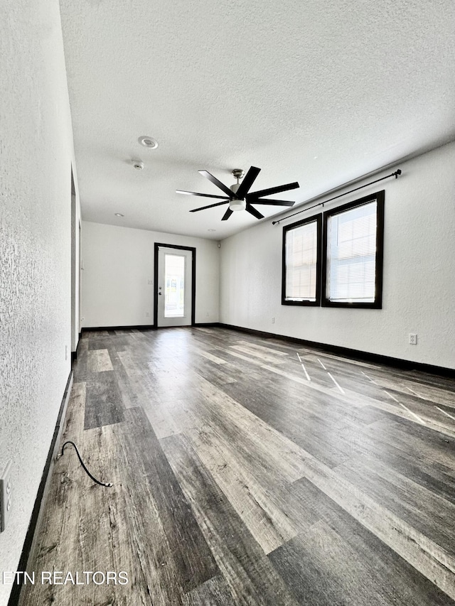 321 Coleman St, Harrogate, TN 37752 - empty room with wood finished floors, a textured wall, a ceiling fan, a textured ceiling, and baseboards