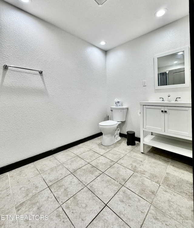 321 Coleman St, Harrogate, TN 37752 - bathroom with vanity, a textured wall, toilet, tile patterned floors, and recessed lighting