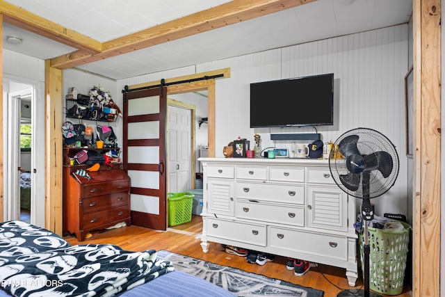 4884 Jones Cove Rd, Cosby, TN 37722 - bedroom featuring a barn door and light wood-style floors