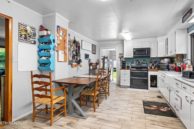4884 Jones Cove Rd, Cosby, TN 37722 - kitchen with stainless steel appliances, ornamental molding, backsplash, white cabinetry, and light countertops