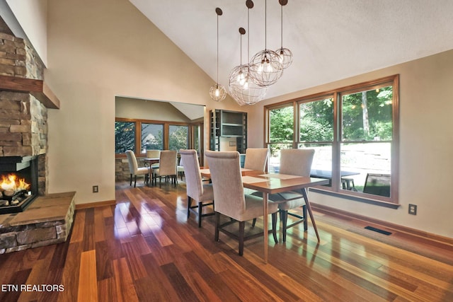 104 Maltese Ln, Oak Ridge, TN 37830 - dining area with dark wood finished floors, high vaulted ceiling, a fireplace, baseboards, and a chandelier