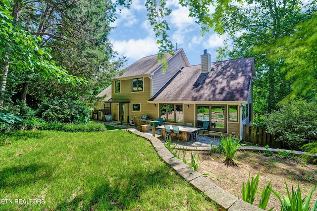 104 Maltese Ln, Oak Ridge, TN 37830 - back of property featuring a patio area, a chimney, and roof with shingles