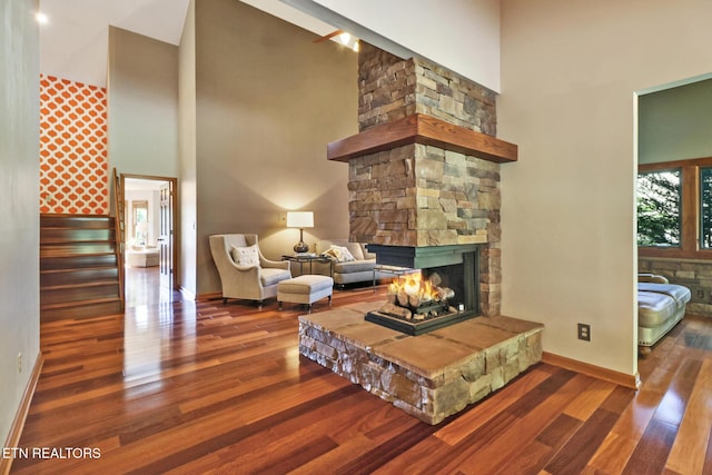 104 Maltese Ln, Oak Ridge, TN 37830 - living area featuring a high ceiling, a stone fireplace, wood finished floors, baseboards, and stairs