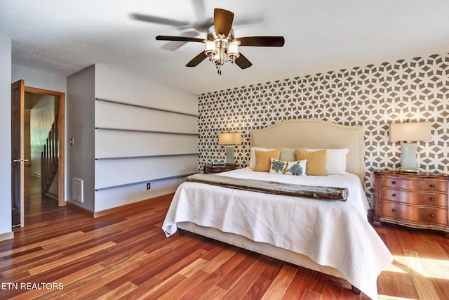 104 Maltese Ln, Oak Ridge, TN 37830 - bedroom with wood finished floors, wallpapered walls, baseboards, and a ceiling fan