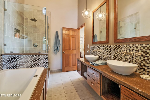 104 Maltese Ln, Oak Ridge, TN 37830 - bathroom with a tile shower, backsplash, double vanity, and tiled bath