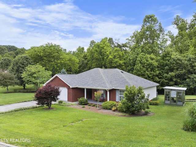 1713 Haley Glenn Ln, Knoxville, TN 37920 - view of front of home featuring a front lawn, brick siding, driveway, a shingled roof, and a garage