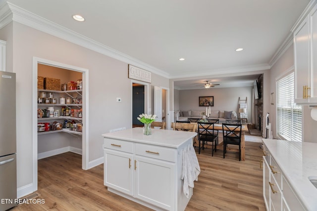 111 Chaseberry Rd, Oak Ridge, TN 37830 - kitchen featuring freestanding refrigerator, ornamental molding, light wood-style floors, light countertops, and white cabinetry