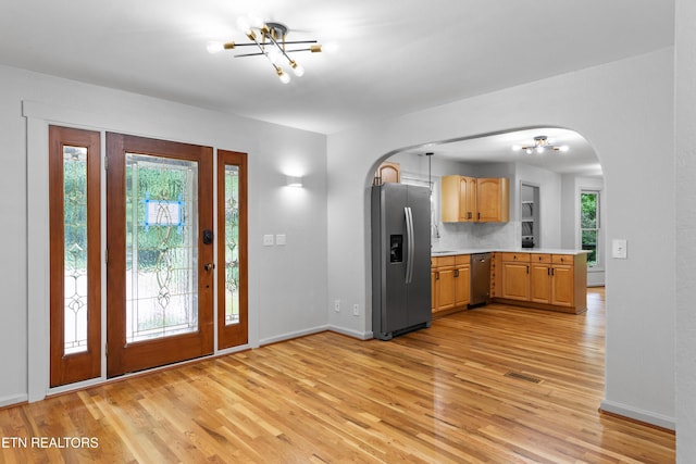 120 Kingdom Ln, Walland, TN 37886 - foyer entrance featuring a chandelier, arched walkways, and light wood-style floors