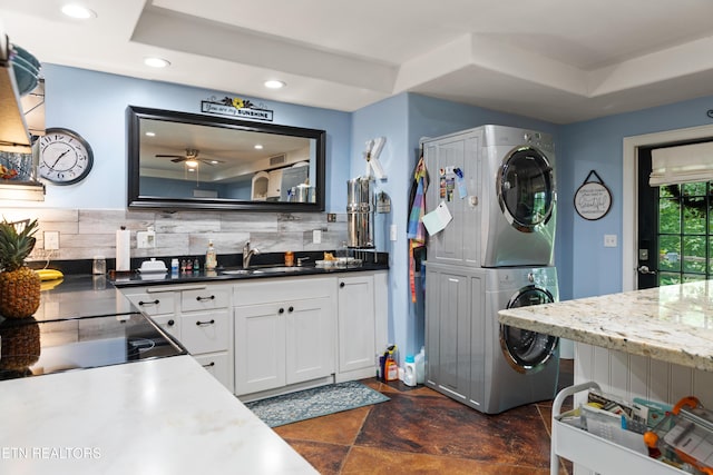 120 Kingdom Ln, Walland, TN 37886 - kitchen featuring stacked washer / drying machine, tasteful backsplash, a sink, white cabinets, and a ceiling fan