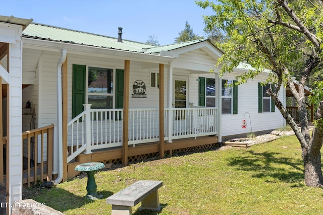 1159 Ditney Ln, Sevierville, TN 37876 - view of front of house with covered porch, a front lawn, and metal roof