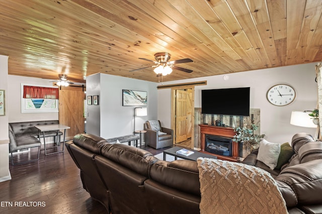 1159 Ditney Ln, Sevierville, TN 37876 - living room with ceiling fan, wood ceiling, a glass covered fireplace, and wood-type flooring