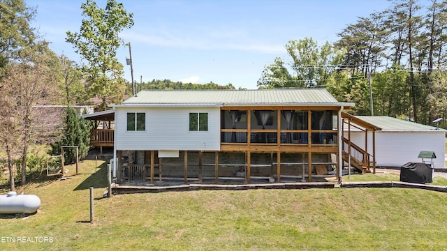 1159 Ditney Ln, Sevierville, TN 37876 - back of house featuring a yard, metal roof, and a sunroom