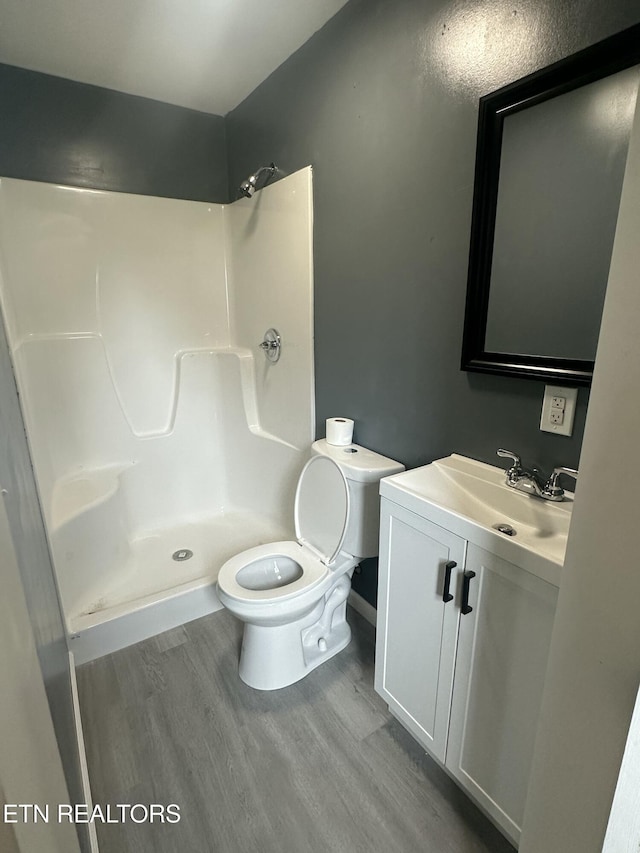 1059 Hale Rd, Dandridge, TN 37725 - full bathroom featuring toilet, wood finished floors, vanity, and a shower