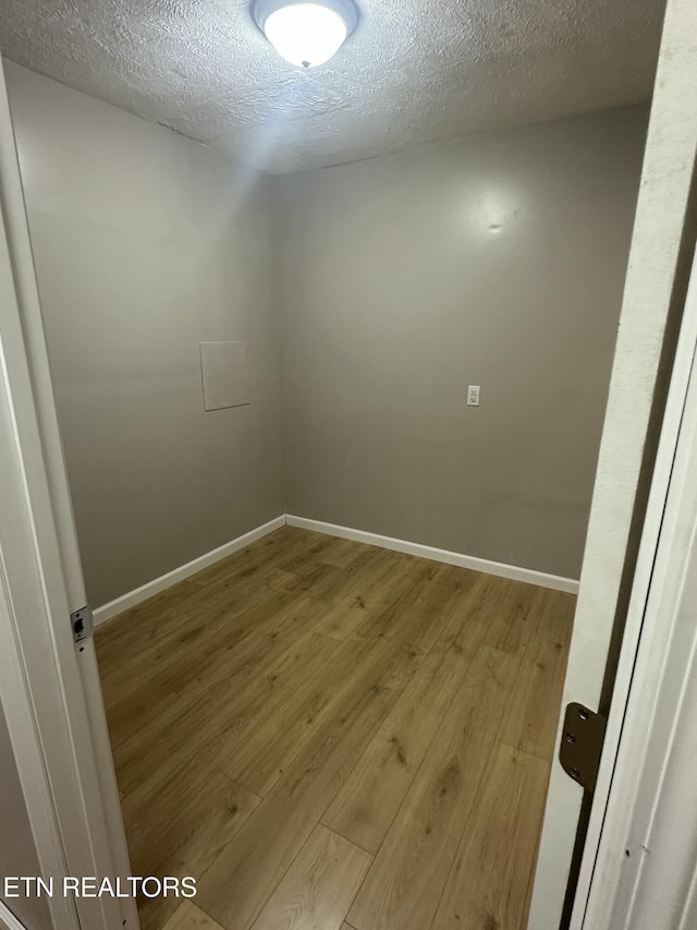 1059 Hale Rd, Dandridge, TN 37725 - unfurnished room with wood finished floors, a textured ceiling, and baseboards