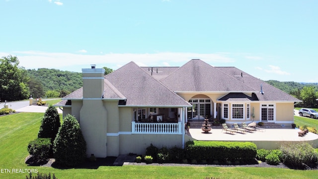 109 Divot Pl, Tazewell, TN 37879 - back of property featuring french doors, a patio area, a chimney, and stucco siding