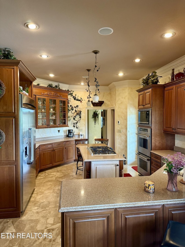 109 Divot Pl, Tazewell, TN 37879 - kitchen with stainless steel appliances, brown cabinetry, light stone countertops, crown molding, and a center island