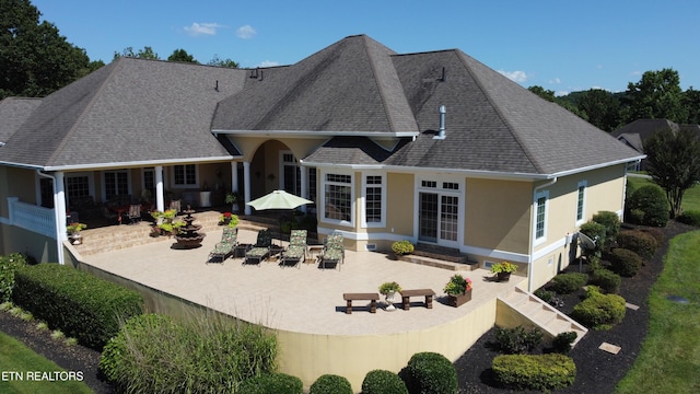 109 Divot Pl, Tazewell, TN 37879 - rear view of house with a patio area, stucco siding, roof with shingles, and entry steps