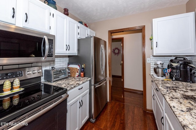 2368 Governors Ct, Maryville, TN 37801 - kitchen featuring stainless steel appliances, dark wood-style flooring, white cabinetry, decorative backsplash, and light stone counters