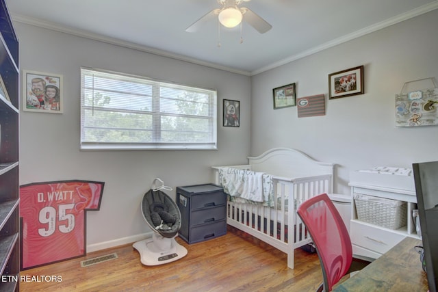 809 Topoca Trl, Athens, TN 37303 - bedroom with ornamental molding, wood finished floors, multiple windows, a crib, and a ceiling fan