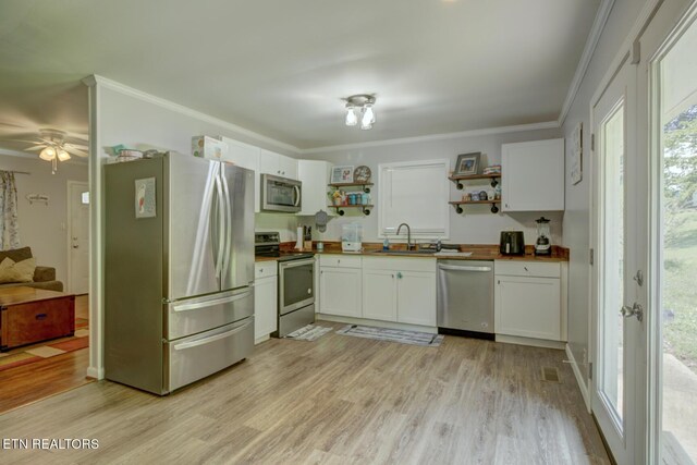 809 Topoca Trl, Athens, TN 37303 - kitchen featuring stainless steel appliances, open shelves, a sink, white cabinetry, and ornamental molding