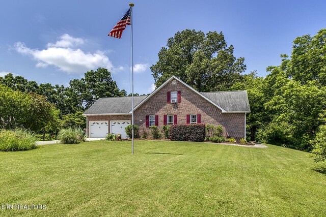 111 Ellis St, Vonore, TN 37885 - view of front facade with a garage, a front lawn, and brick siding
