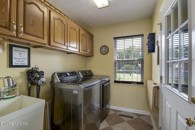 111 Ellis St, Vonore, TN 37885 - washroom featuring independent washer and dryer, cabinet space, baseboards, and a textured ceiling