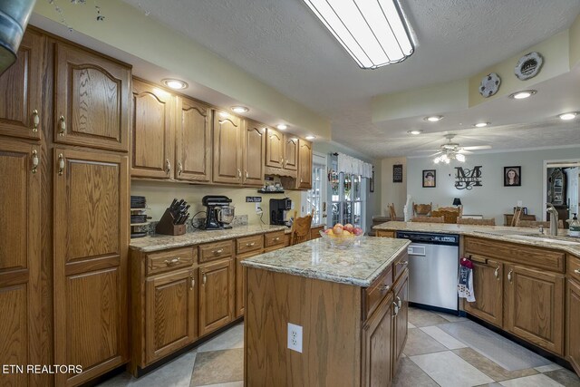 111 Ellis St, Vonore, TN 37885 - kitchen featuring dishwasher, a kitchen island, a sink, brown cabinetry, and a ceiling fan