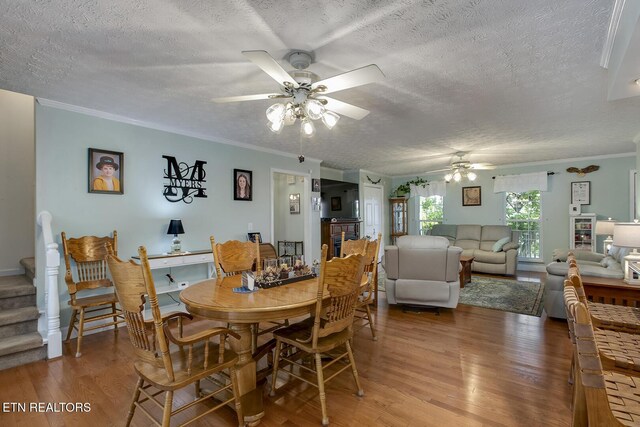 111 Ellis St, Vonore, TN 37885 - dining space featuring a ceiling fan, a textured ceiling, light wood finished floors, ornamental molding, and stairs