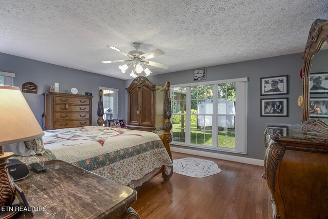 111 Ellis St, Vonore, TN 37885 - bedroom with wood finished floors, baseboards, a ceiling fan, and a textured ceiling