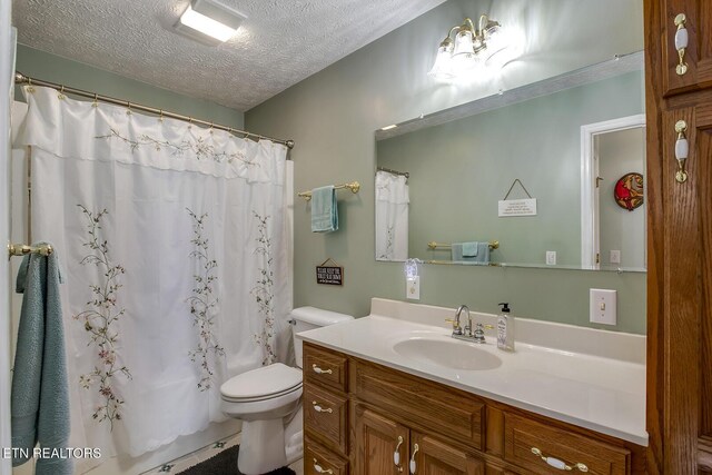 111 Ellis St, Vonore, TN 37885 - bathroom with vanity, toilet, a textured ceiling, and curtained shower