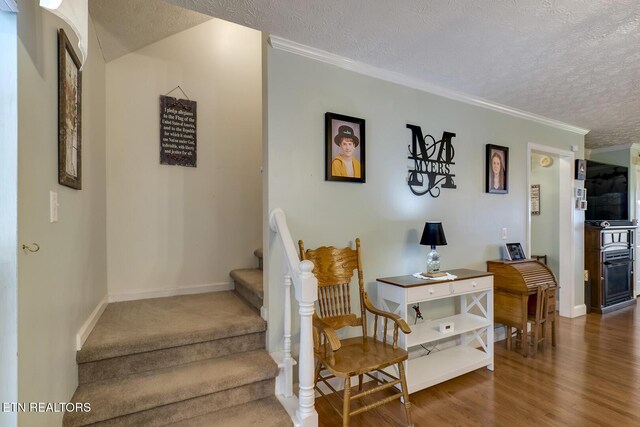 111 Ellis St, Vonore, TN 37885 - stairway with a textured ceiling, wood finished floors, crown molding, and baseboards