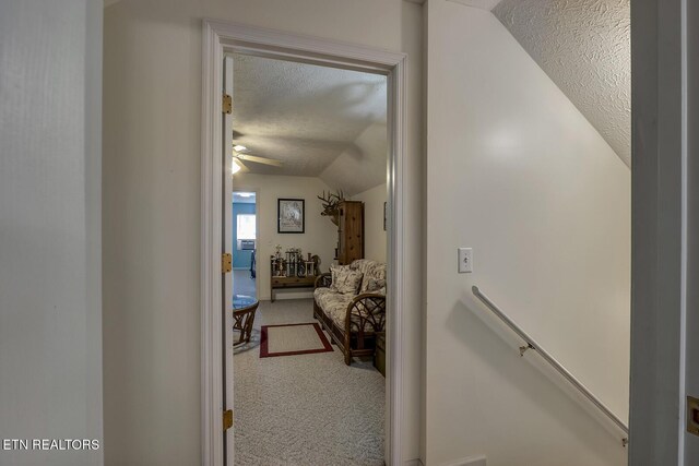 111 Ellis St, Vonore, TN 37885 - corridor with a textured ceiling, carpet floors, vaulted ceiling, and an upstairs landing