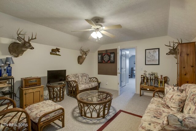 111 Ellis St, Vonore, TN 37885 - carpeted living room featuring vaulted ceiling, ceiling fan, a textured ceiling, and baseboards