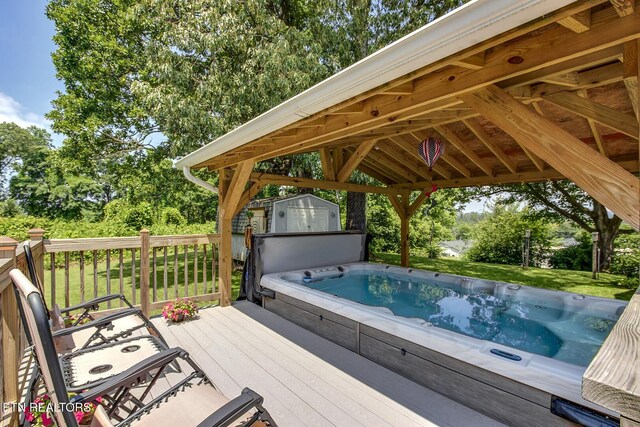 111 Ellis St, Vonore, TN 37885 - wooden terrace with a hot tub, view of wooded area, and a yard