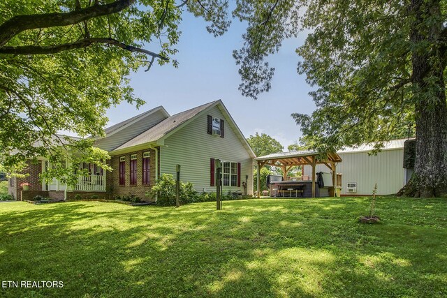 111 Ellis St, Vonore, TN 37885 - back of house with a covered hot tub and a yard