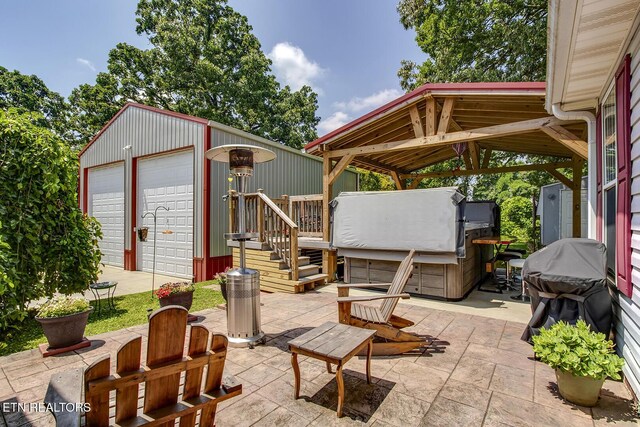 111 Ellis St, Vonore, TN 37885 - view of patio / terrace featuring an outbuilding, a gazebo, a hot tub, and a garage