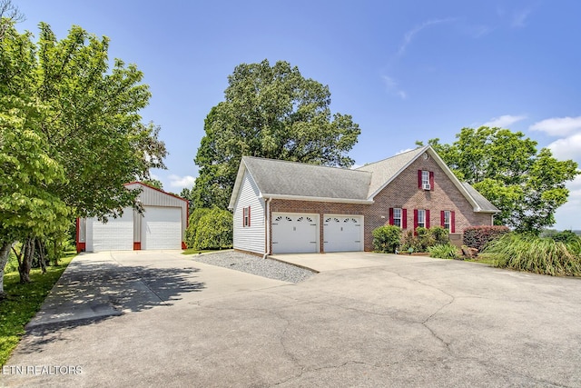 111 Ellis St, Vonore, TN 37885 - traditional home featuring brick siding, a detached garage, roof with shingles, and an outdoor structure
