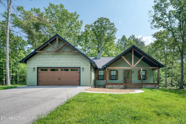 191 Creekview Ct, Jamestown, TN 38556 - view of front of house featuring driveway, a porch, a front lawn, a chimney, and a garage