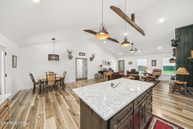 191 Creekview Ct, Jamestown, TN 38556 - kitchen featuring light wood-type flooring, ceiling fan, hanging light fixtures, dark brown cabinetry, and high vaulted ceiling