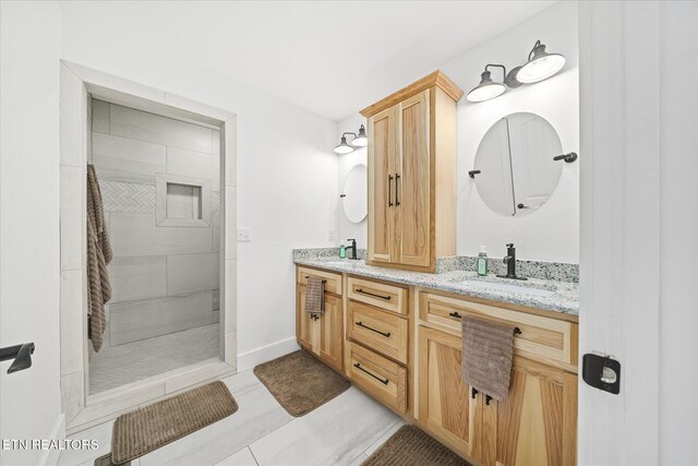 191 Creekview Ct, Jamestown, TN 38556 - bathroom with double vanity, a tile shower, baseboards, and tile patterned flooring