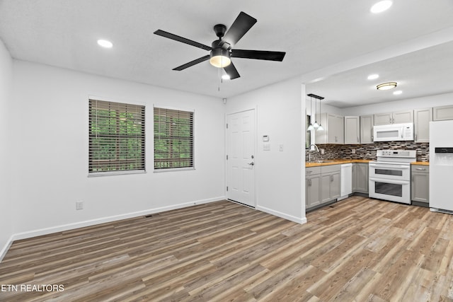 321 Ailey Rd, Dandridge, TN 37725 - kitchen featuring white appliances, light wood-style floors, recessed lighting, tasteful backsplash, and baseboards