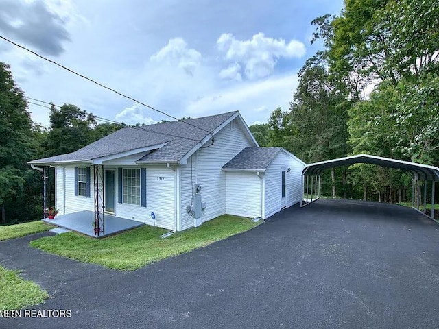 1517 W Copeland Dr, Powell, TN 37849 - view of front of home with a carport, driveway, and roof with shingles