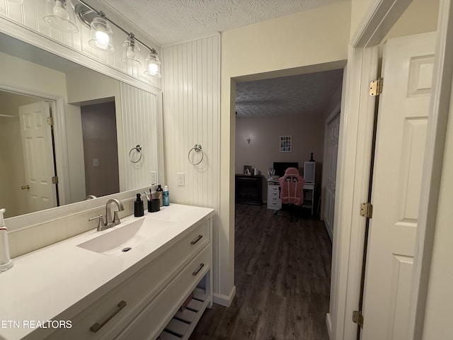1517 W Copeland Dr, Powell, TN 37849 - bathroom featuring a textured ceiling, wood finished floors, and vanity