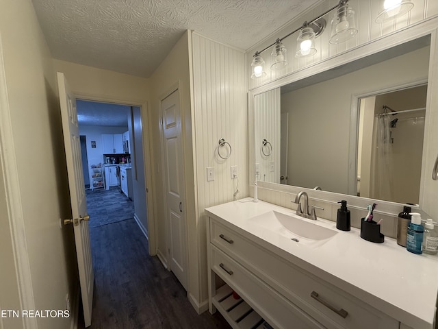 1517 W Copeland Dr, Powell, TN 37849 - bathroom featuring vanity, wood finished floors, a textured ceiling, and a shower with curtain